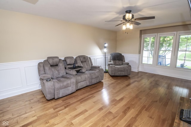 917 E Mill Creek Rd S, Greensburg, IN 47240 - living room with a ceiling fan, a decorative wall, light wood-style flooring, and wainscoting