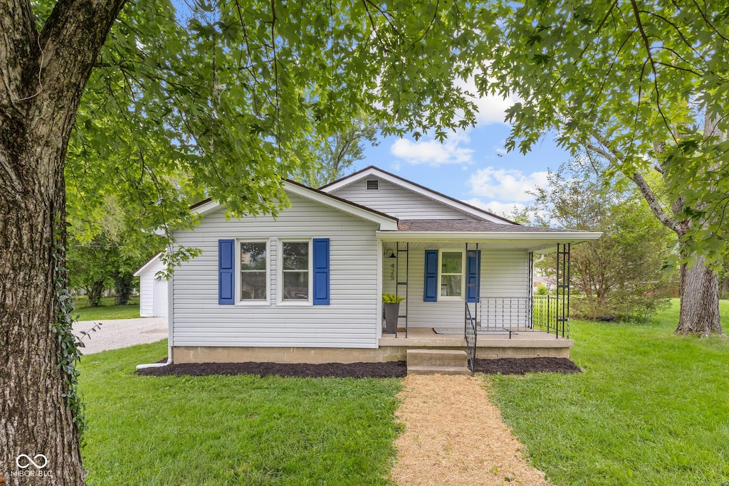 425 Patterson Rd, Columbus, IN 47203 - view of front facade featuring covered porch, a front lawn, and a shingled roof