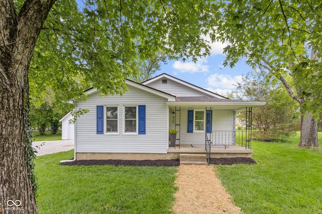 425 Patterson Rd, Columbus, IN 47203 - view of front facade featuring covered porch, a front lawn, and a shingled roof