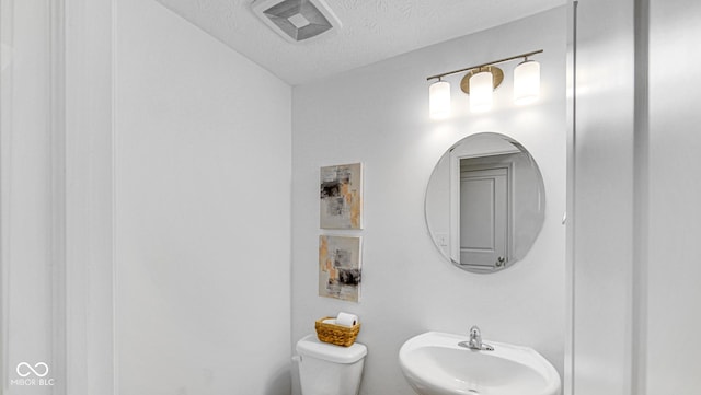 9717 Chuckwalla Pl, Fishers, IN 46040 - bathroom with a sink, a textured ceiling, and toilet