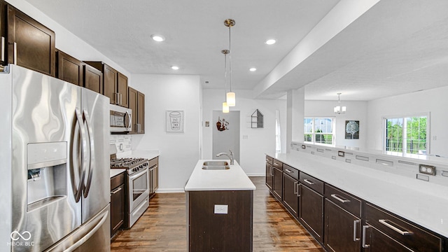 9717 Chuckwalla Pl, Fishers, IN 46040 - kitchen featuring appliances with stainless steel finishes, a sink, decorative backsplash, dark wood-style floors, and light countertops