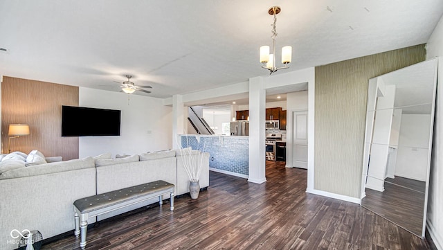 9717 Chuckwalla Pl, Fishers, IN 46040 - living area featuring wallpapered walls, an accent wall, dark wood-style floors, baseboards, and a chandelier