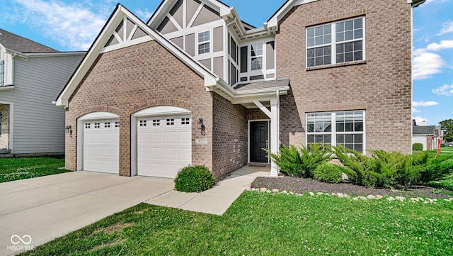 9717 Chuckwalla Pl, Fishers, IN 46040 - view of front facade with driveway, brick siding, a front lawn, and an attached garage