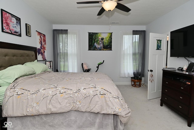 2330 Oak Dr, Clayton, IN 46118 - bedroom with light carpet, multiple windows, baseboards, and a ceiling fan