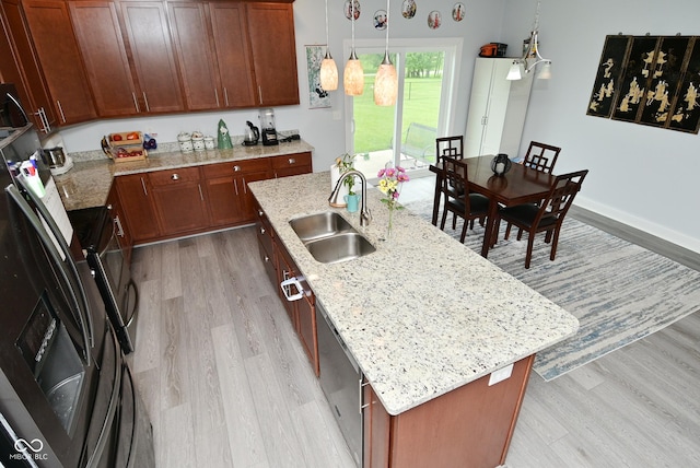 2330 Oak Dr, Clayton, IN 46118 - kitchen featuring a sink, light wood finished floors, a center island with sink, and light stone countertops