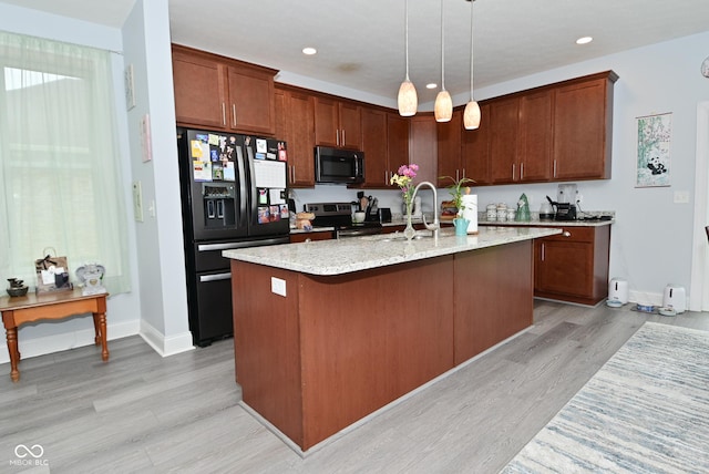 2330 Oak Dr, Clayton, IN 46118 - kitchen featuring black refrigerator with ice dispenser, stainless steel electric stove, light wood-style flooring, baseboards, and a kitchen island with sink