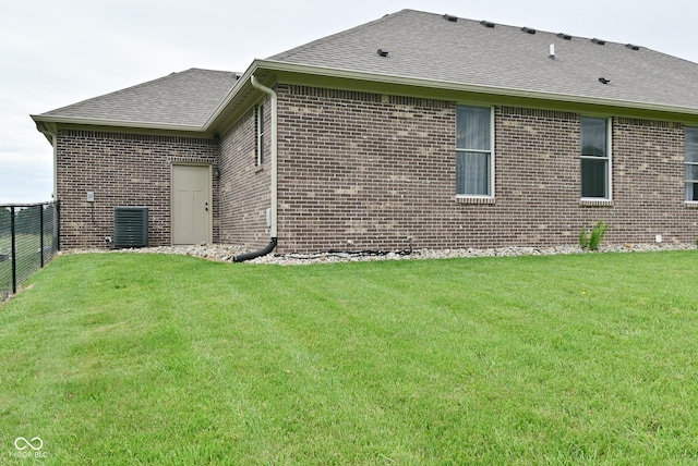 2330 Oak Dr, Clayton, IN 46118 - view of property exterior featuring a shingled roof, brick siding, and central AC unit