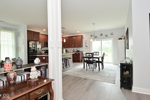2330 Oak Dr, Clayton, IN 46118 - dining area with light wood-style floors, ornate columns, recessed lighting, and baseboards