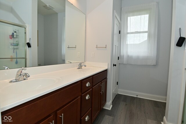 2330 Oak Dr, Clayton, IN 46118 - full bathroom with wood finished floors, double vanity, baseboards, and a shower stall