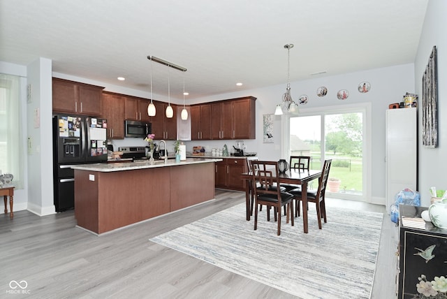 2330 Oak Dr, Clayton, IN 46118 - kitchen with appliances with stainless steel finishes, light wood-type flooring, light countertops, hanging light fixtures, and recessed lighting