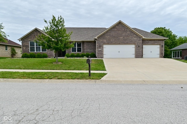 2330 Oak Dr, Clayton, IN 46118 - view of front of property featuring a garage, a front lawn, brick siding, and concrete driveway