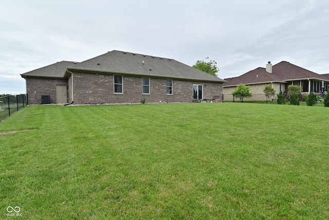 2330 Oak Dr, Clayton, IN 46118 - back of house featuring brick siding, roof with shingles, and central AC unit