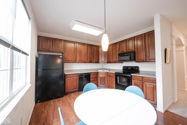 9117 Thoreau Ct, Fishers, IN 46037 - kitchen featuring black appliances, a sink, light wood finished floors, and baseboards