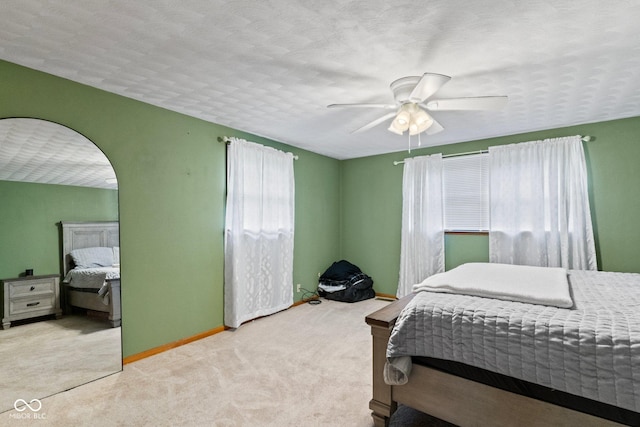 2137 W Bobwhite Dr, Scottsburg, IN 47170 - bedroom with carpet, baseboards, ceiling fan, and arched walkways