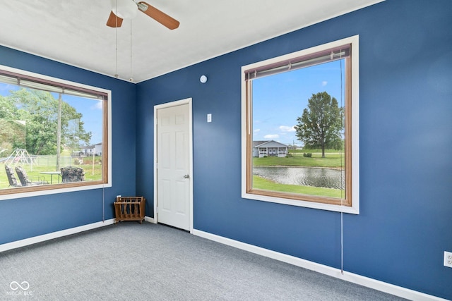 2137 W Bobwhite Dr, Scottsburg, IN 47170 - spare room featuring baseboards, carpet floors, a ceiling fan, and a water view