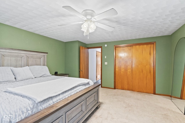 2137 W Bobwhite Dr, Scottsburg, IN 47170 - bedroom with baseboards, light carpet, ceiling fan, and a closet