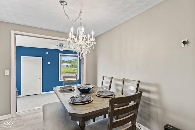 2137 W Bobwhite Dr, Scottsburg, IN 47170 - dining area featuring a chandelier, light wood finished floors, baseboards, and a ceiling fan