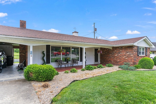 2137 W Bobwhite Dr, Scottsburg, IN 47170 - single story home featuring covered porch, a front yard, brick siding, and a chimney