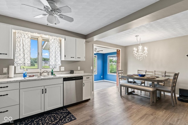 2137 W Bobwhite Dr, Scottsburg, IN 47170 - kitchen featuring dishwasher, a sink, white cabinets, a chandelier, and wood finished floors