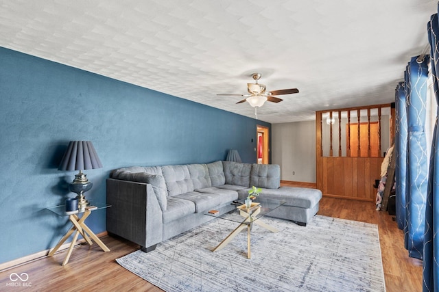 2137 W Bobwhite Dr, Scottsburg, IN 47170 - living room with wood finished floors, a ceiling fan, and baseboards