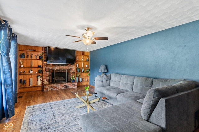 2137 W Bobwhite Dr, Scottsburg, IN 47170 - living area featuring ceiling fan, wood finished floors, and a fireplace