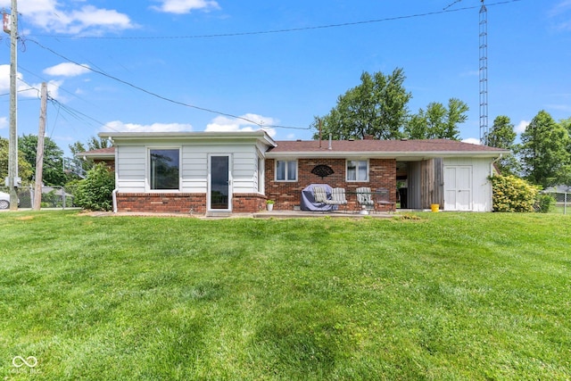 2137 W Bobwhite Dr, Scottsburg, IN 47170 - rear view of house featuring a lawn, brick siding, and a patio