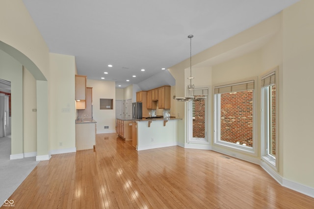 11065 Spice Ln, Fishers, IN 46037 - unfurnished living room featuring light wood-type flooring, arched walkways, and recessed lighting