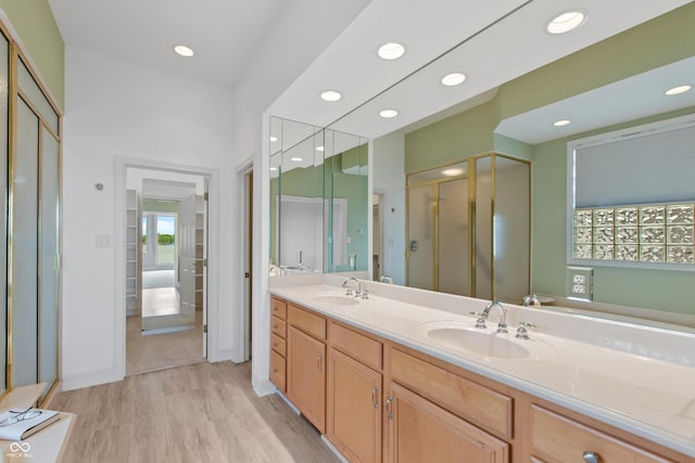 11065 Spice Ln, Fishers, IN 46037 - full bathroom featuring wood finished floors, a shower stall, double vanity, and recessed lighting