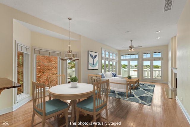 11065 Spice Ln, Fishers, IN 46037 - dining room with light wood-type flooring, ceiling fan, and a chandelier