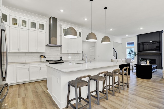 1364 Chatham Hills Blvd, Westfield, IN 46074 - kitchen featuring wall chimney range hood, a sink, stainless steel appliances, light wood-style flooring, and tasteful backsplash
