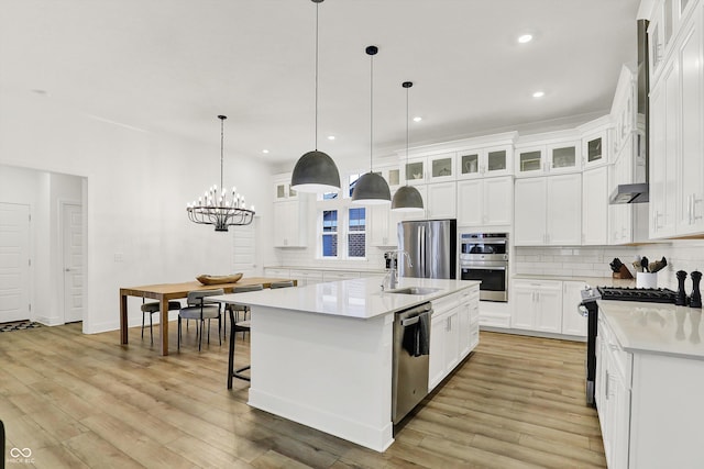 1364 Chatham Hills Blvd, Westfield, IN 46074 - kitchen featuring appliances with stainless steel finishes, backsplash, light countertops, glass insert cabinets, and recessed lighting