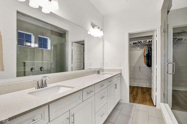 1364 Chatham Hills Blvd, Westfield, IN 46074 - full bathroom with a spacious closet, a stall shower, double vanity, and tile patterned flooring