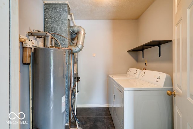 444 Austin Dr, Avon, IN 46123 - laundry area with washing machine and clothes dryer, water heater, dark tile patterned floors, baseboards, and a textured ceiling