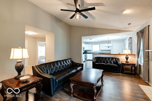 444 Austin Dr, Avon, IN 46123 - living room with vaulted ceiling, ceiling fan, dark wood-style flooring, and a chandelier