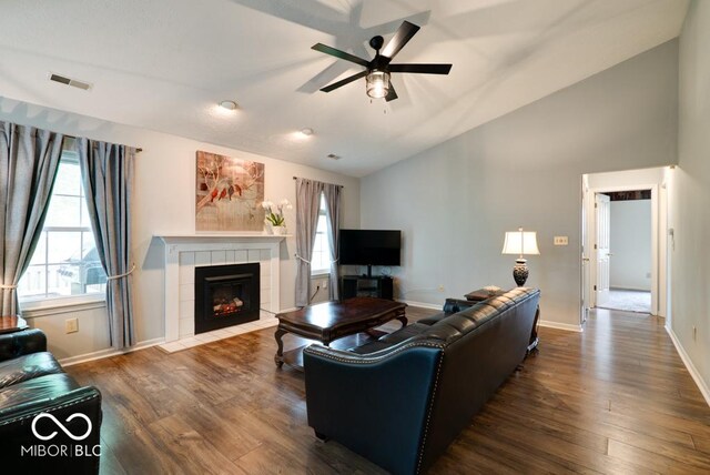 444 Austin Dr, Avon, IN 46123 - living area featuring a ceiling fan, a tile fireplace, wood finished floors, baseboards, and high vaulted ceiling