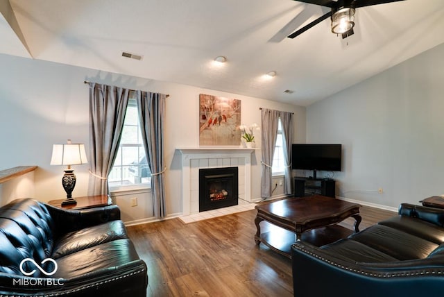 444 Austin Dr, Avon, IN 46123 - living area with vaulted ceiling, a ceiling fan, wood finished floors, a tile fireplace, and baseboards