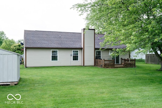 444 Austin Dr, Avon, IN 46123 - back of property featuring a lawn, a shingled roof, a deck, and a chimney