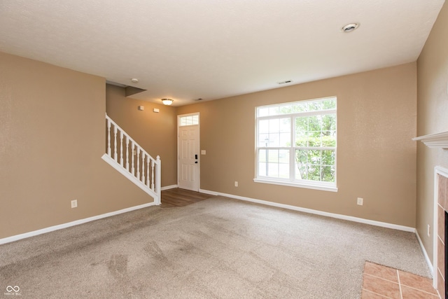 3623 Carroll Farms Dr, Indianapolis, IN 46235 - carpeted foyer featuring stairs, baseboards, and a fireplace