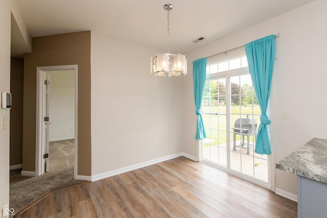 3623 Carroll Farms Dr, Indianapolis, IN 46235 - unfurnished dining area with wood finished floors, a chandelier, and baseboards