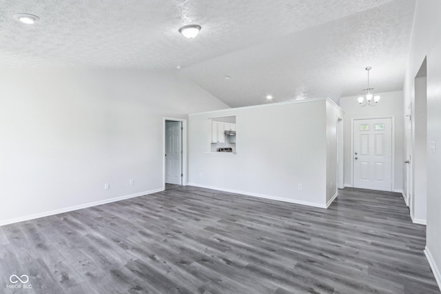 12250 Longstraw Dr, Indianapolis, IN 46236 - unfurnished living room featuring a textured ceiling, a chandelier, dark wood-type flooring, baseboards, and vaulted ceiling