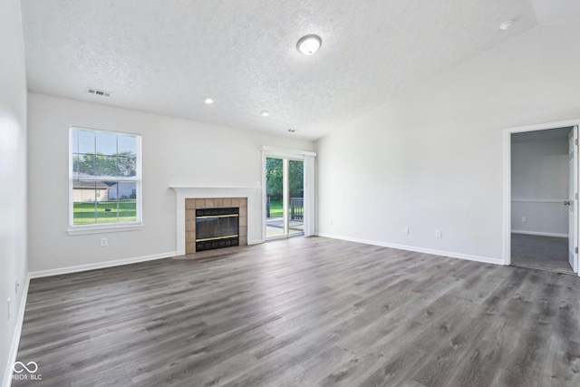 12250 Longstraw Dr, Indianapolis, IN 46236 - unfurnished living room featuring a textured ceiling, wood finished floors, a fireplace, baseboards, and recessed lighting