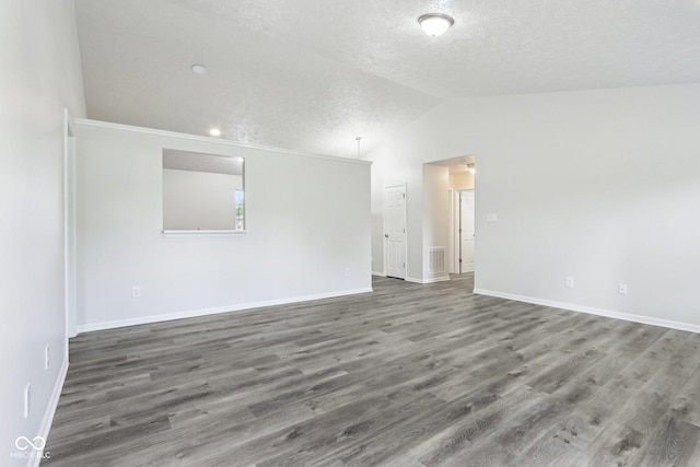 12250 Longstraw Dr, Indianapolis, IN 46236 - empty room with wood finished floors, baseboards, vaulted ceiling, and a textured ceiling