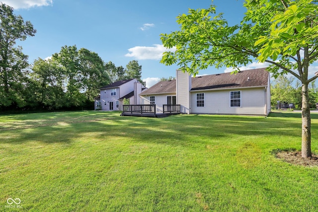 12250 Longstraw Dr, Indianapolis, IN 46236 - rear view of house with a wooden deck, a lawn, and a chimney