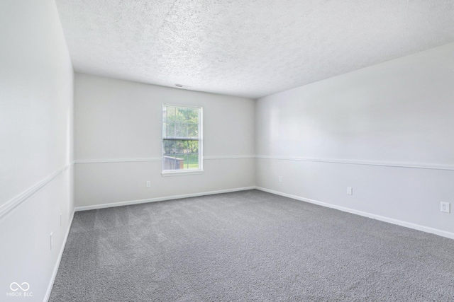 12250 Longstraw Dr, Indianapolis, IN 46236 - carpeted empty room with baseboards and a textured ceiling