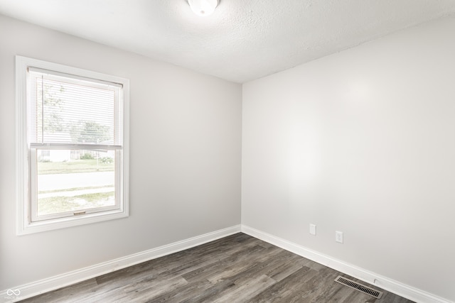 315 Schoolhouse Rd, Franklin, IN 46131 - empty room featuring dark wood-style flooring, baseboards, and a textured ceiling