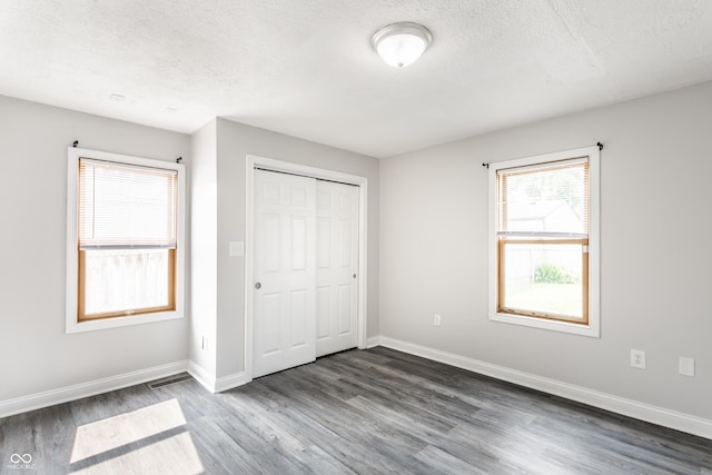 315 Schoolhouse Rd, Franklin, IN 46131 - unfurnished bedroom with dark wood finished floors, a textured ceiling, baseboards, and a closet