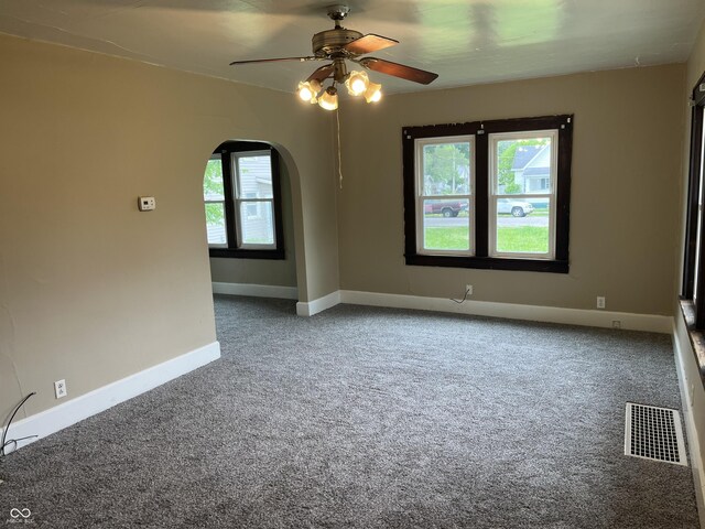 1020 E 30th St, Anderson, IN 46016 - unfurnished room with a ceiling fan, carpet, arched walkways, and baseboards