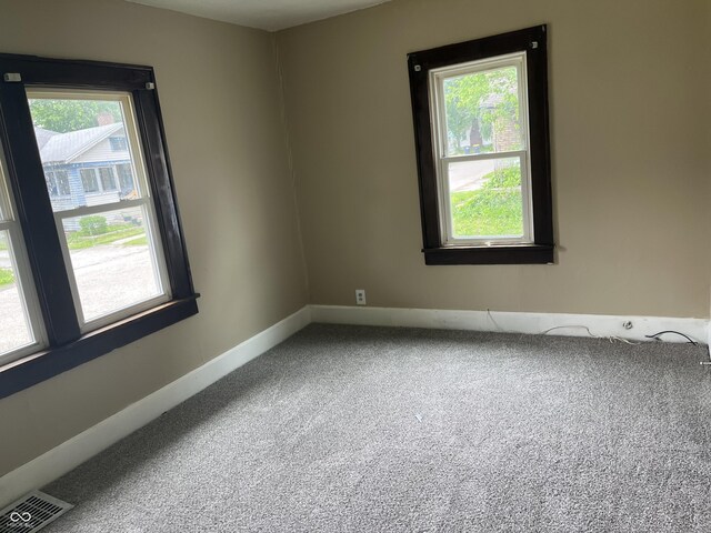 1020 E 30th St, Anderson, IN 46016 - spare room featuring carpet floors and baseboards