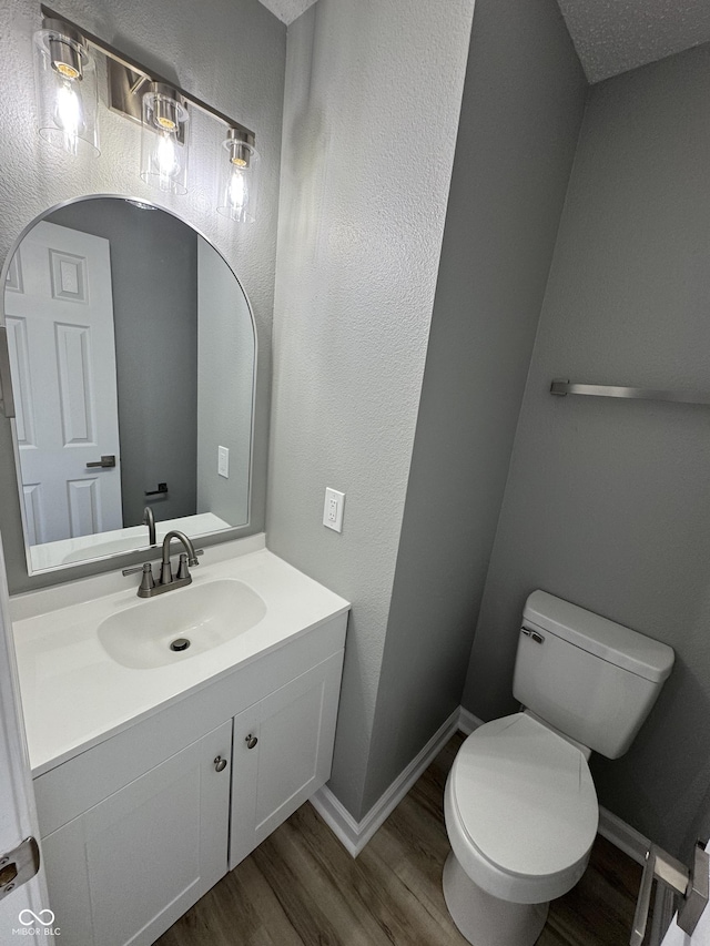 3327 Brandenburg Blvd, Indianapolis, IN 46239 - bathroom featuring wood finished floors, toilet, vanity, and baseboards
