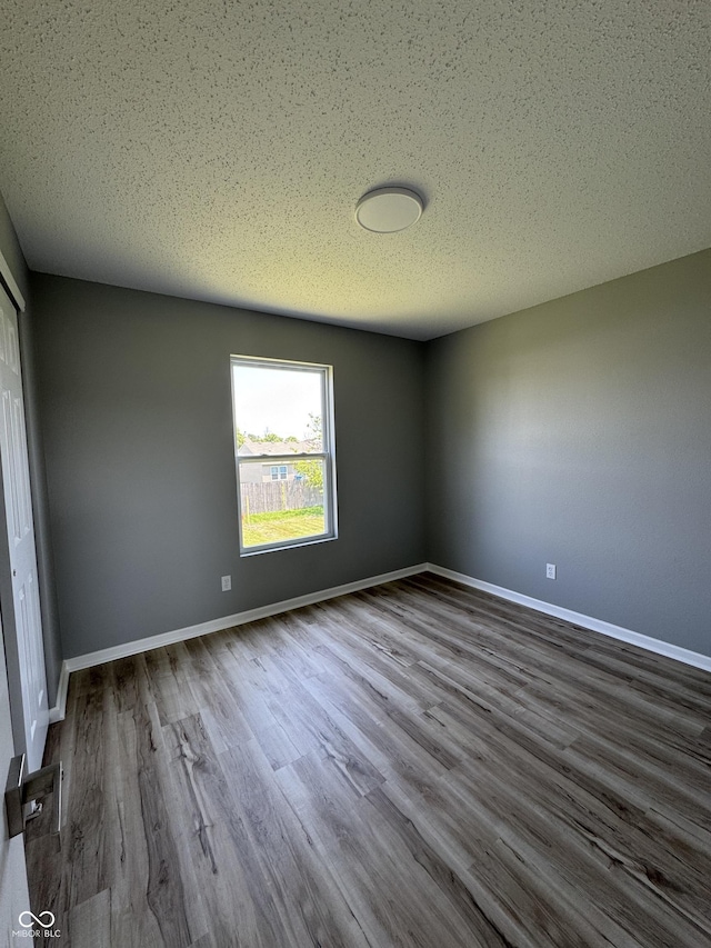 3327 Brandenburg Blvd, Indianapolis, IN 46239 - unfurnished room with wood finished floors, baseboards, and a textured ceiling
